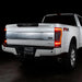 Rear three quarters view of a white Ford Superduty with Flush Mount Tail Lights installed, and brake lights on.