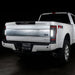 Rear three quarters view of a white Ford Superduty, with Flush Mount Tail Lights installed, and reverse lights on.