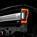 Close up on the rear end of a black Ford Superduty with Flush Mount Tail Lights installed, and reverse lights on.