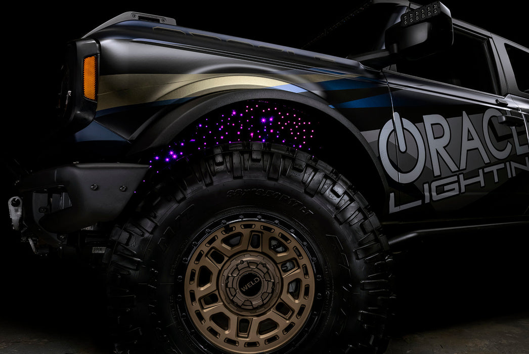 Low shot of fiber optic wheel liner kit installed with pink LED lighting.