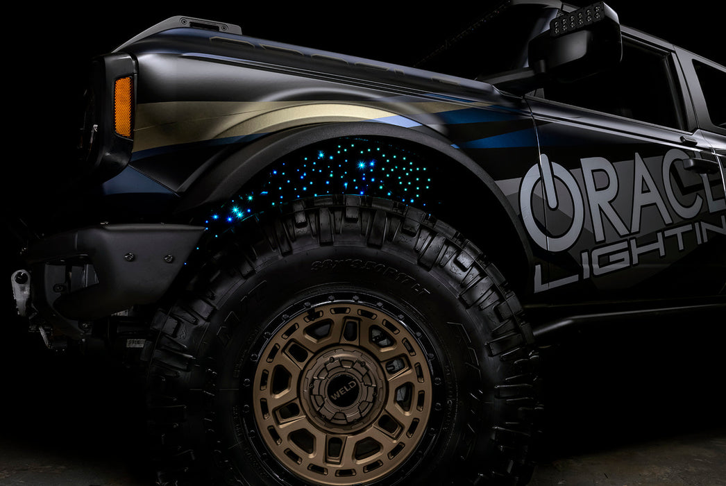 Low shot of fiber optic wheel liner kit installed with cyan LED lighting.