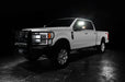 Three quarters view of a white Ford SuperDuty with LED Off-Road Side Mirrors turned on.