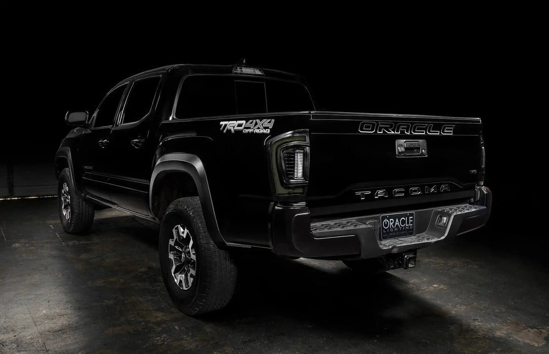 Rear three quarters view of black Toyota Tacoma with tinted Flush Style LED Tail Lights installed