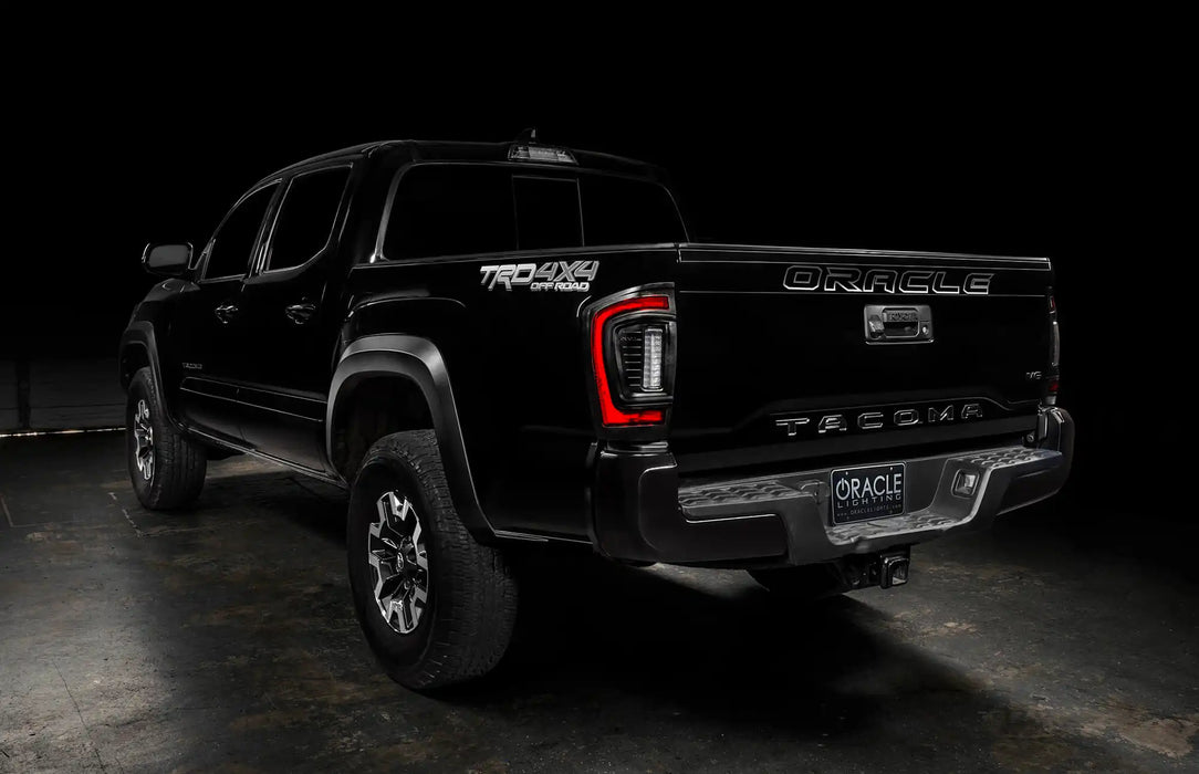 Rear three quarters view of black Toyota Tacoma focused on the Flush Style LED Tail Lights installed