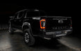 Rear view of black Toyota Tacoma with Flush Style LED Tail Lights installed and running lights on