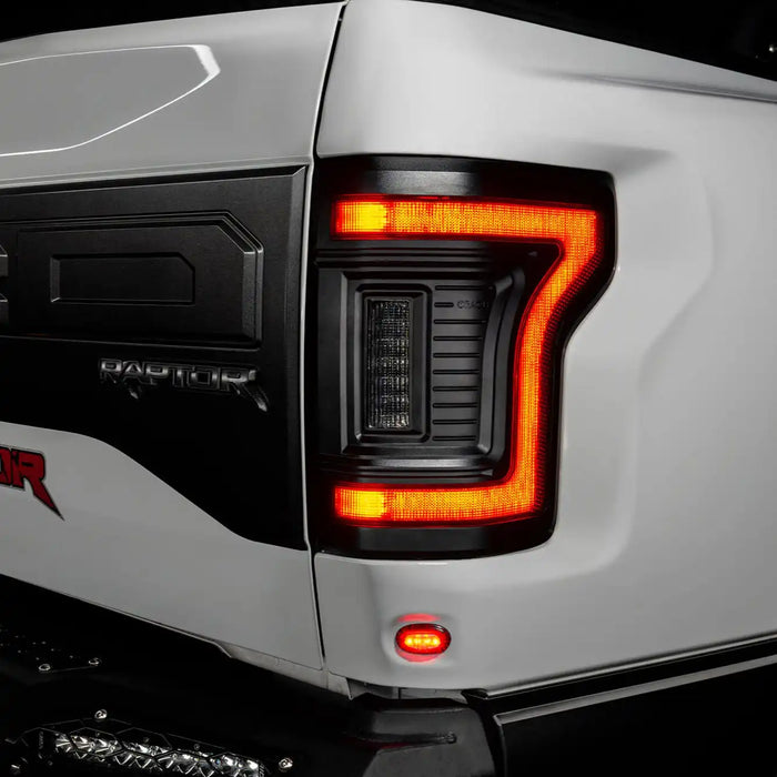 Close up of Flush Style LED Tail Lights installed on white Ford Raptor with running lights on