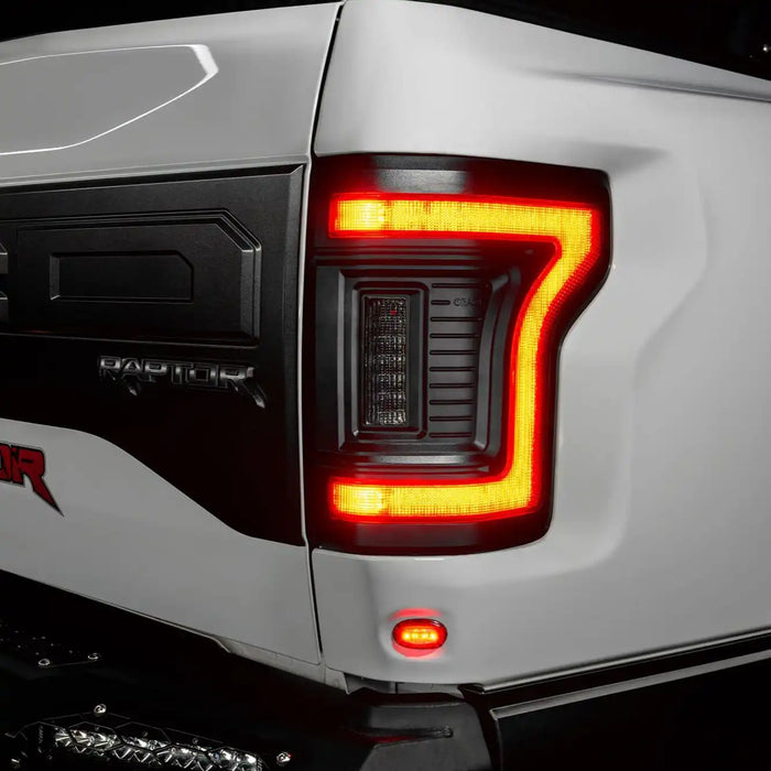 Close up of Flush Style LED Tail Lights installed on white Ford Raptor with brake lights on