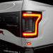 Close up of Flush Style LED Tail Lights installed on white Ford Raptor with brake lights on
