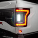 Close up of Flush Style LED Tail Lights installed on white Ford Raptor with reverse lights on