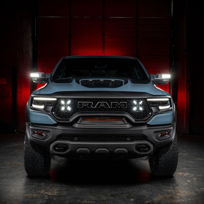 Straight front view of a RAM TRX with LED Off-Road Side Mirror Ditch Lights installed and turned on