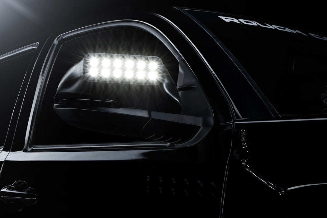 Close up of glowing LED Off-Road Side Mirror Ditch Lights installed on Toyota Tacoma