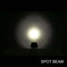 Light fixture emitting a spot beam in a dark setting with 'SPOT BEAM' text below.