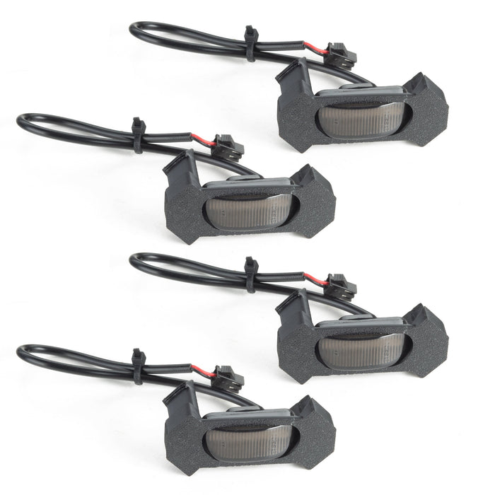 Four black LED fog lights with wiring on a white background