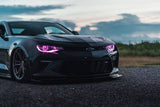 Front end of a Chevrolet Camaro with pink headlight DRLs.