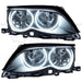 BMW 3 Series headlights with white LED halo rings.