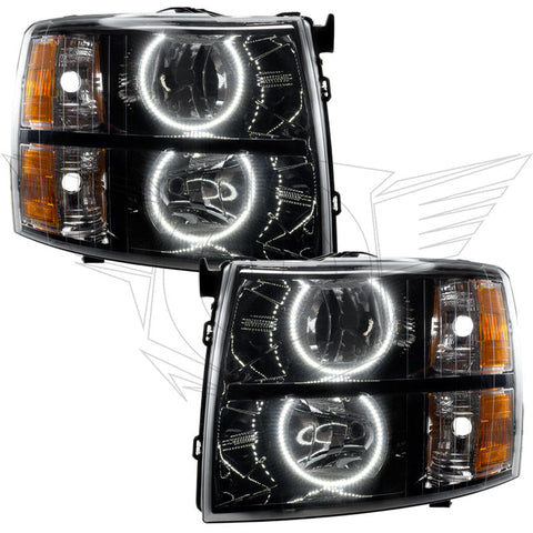 Chevrolet Silverado headlights with black housing and white LED halo rings.