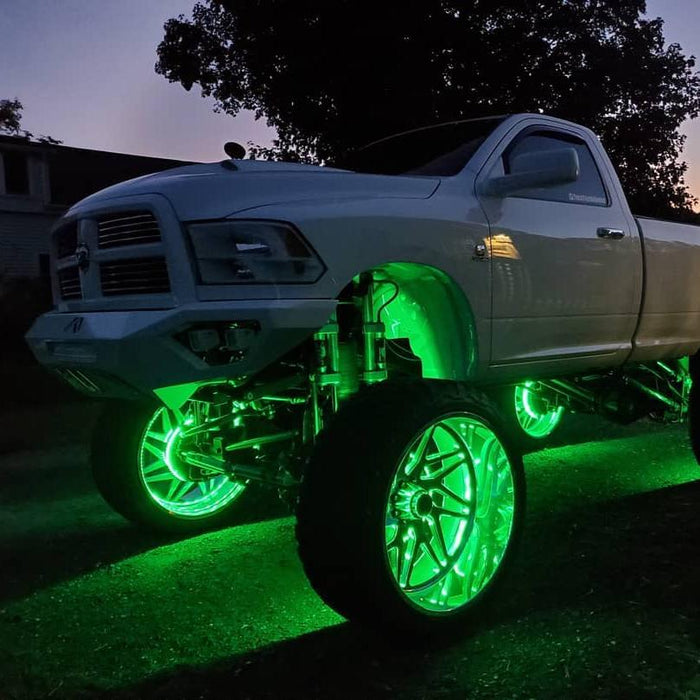 White truck with green LED wheel rings.