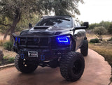 Three quarters view of a black RAM 1500 with blue headlight halos.