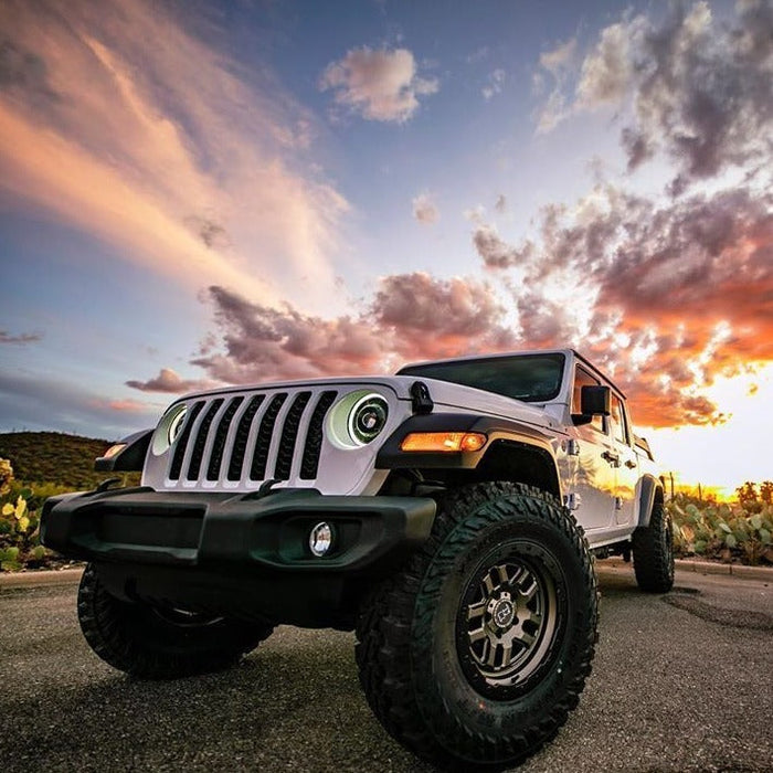 Three quarters view of a white Jeep Gladiator with Oculus Headlights installed.