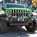 Front end of a green Jeep Wrangler with Oculus Headlights installed.