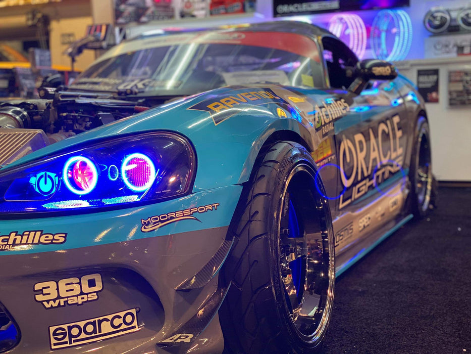 Close-up of Dodge Viper headlights with red projector demon eyes.
