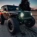 Three quarters view of a Jeep Wrangler with Oculus Headlights turned on.