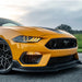 Close-up of a Ford Mustang headlight with yellow LEDs.