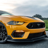 Close-up of a Ford Mustang headlight with yellow LEDs.