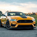Three quarters view of yellow Ford Mustang with cyan LED headlights.
