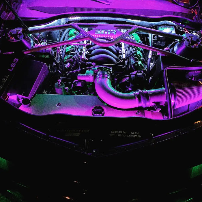 Engine bay with pink LED lighting strips.