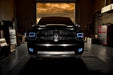 Front end of a RAM truck with Switchback Quad Pre-Assembled Halo Headlights installed and white halos on.