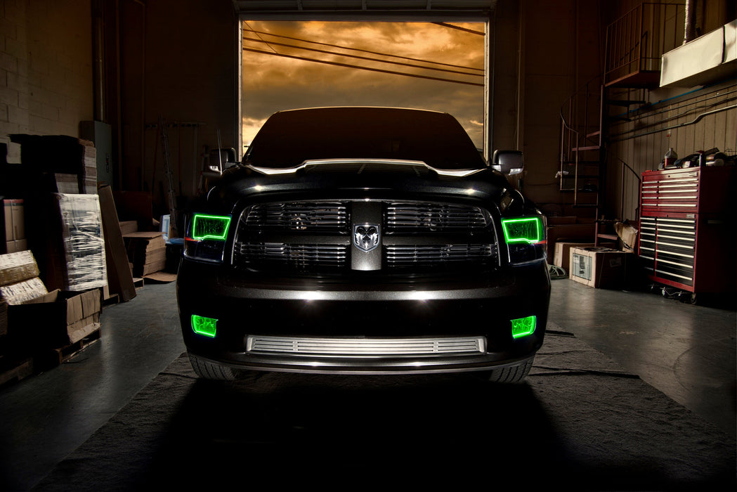 Front end of a RAM truck with Switchback Quad Pre-Assembled Halo Headlights installed and green halos on.