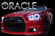 Front end of a red Dodge Charger with white LED headlight halo rings installed.