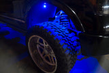 Close up of a wheel well with blue rock light glowing.