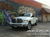 Three quarters view of a Dodge Ram with white LED headlight halo rings installed.