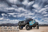 Three quarters view of a black Dodge Ram with white halo rings installed.