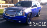 Three quarters view of a GMC Yukon with white LED headlight halo rings installed.