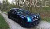 Three quarters view of a Cadillac STS with blue LED headlight halo rings installed.