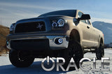 Three quarters view of a Toyota Tundra with white LED headlight halo rings.