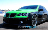 Three quarters view of a Pontiac G8 with white LED headlight halo rings installed.