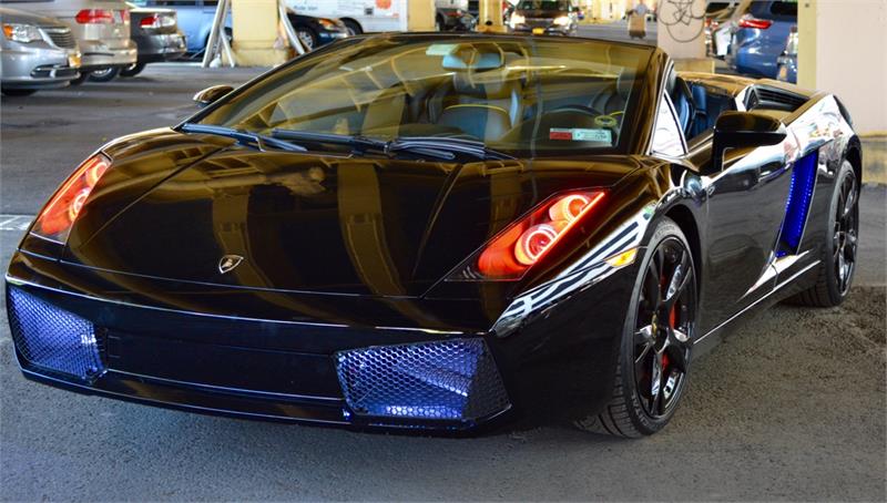 Three quarters view of a Lamborghini Gallardo with amber LED headlight halo rings installed.