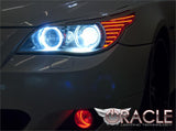 Close-up of white LED headlight halo rings installed on a BMW 5 Series.