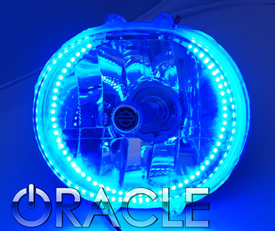 Harley Road Glide headlight with blue LED halo ring installed.