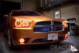 Front end of an orange Dodge Charger with amber LED headlight halo rings installed.