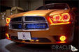 Front end of an orange Dodge Charger with amber LED headlight halo rings installed.