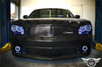 Black charger in a garage with white halos turned on.