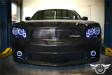 Black charger in a garage with white halos turned on.