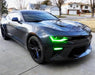 Three quarters view of a black Chevrolet Camaro with green headlight and fog light DRLs.