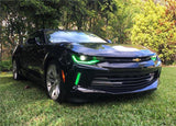 Three quarters view of a black Chevrolet Camaro with green headlight and fog light DRLs.