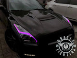 Black Nissan GT-R with pink headlight DRLs.